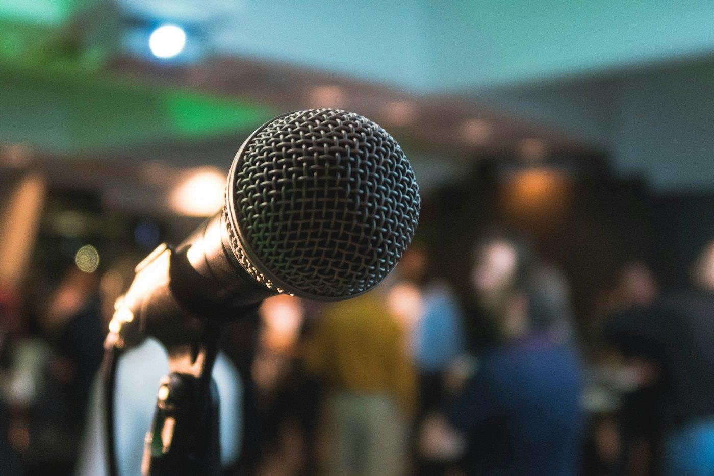 A speaker presenting to a seated audience