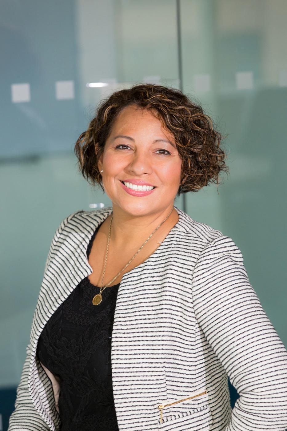 A smiling practice owner in her office
